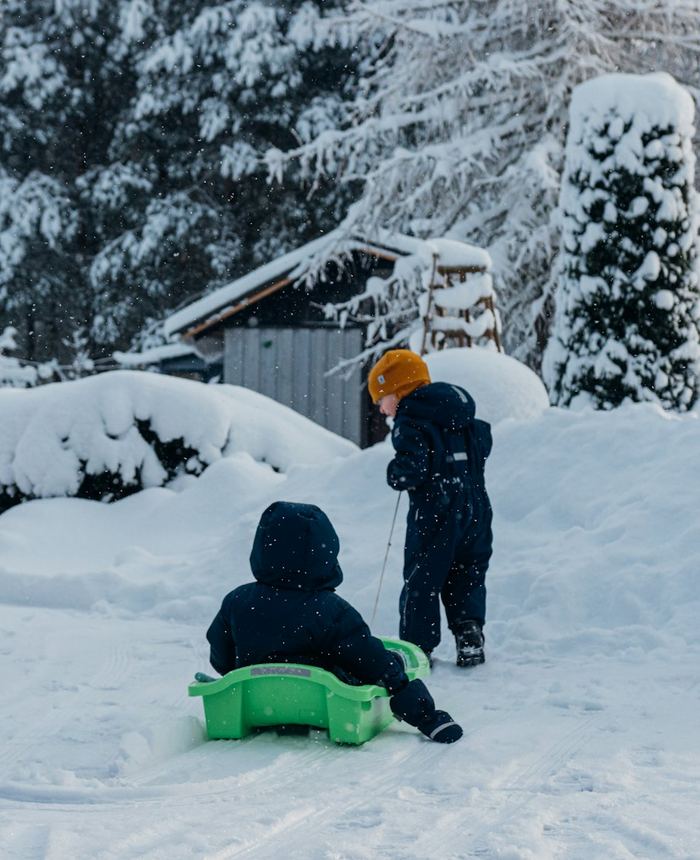 Children sledding in deep snow